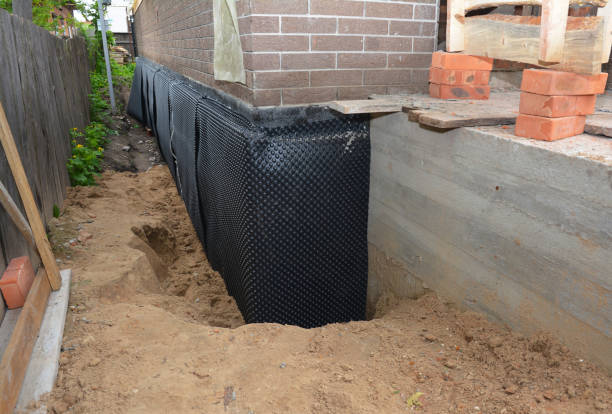 Happy homeowners after waterproofing job in Oneonta